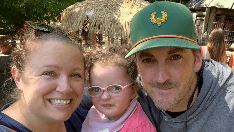 2 parents with a young child on vacation