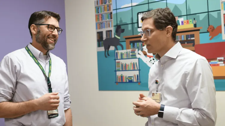 2 doctors conferring in an exam room