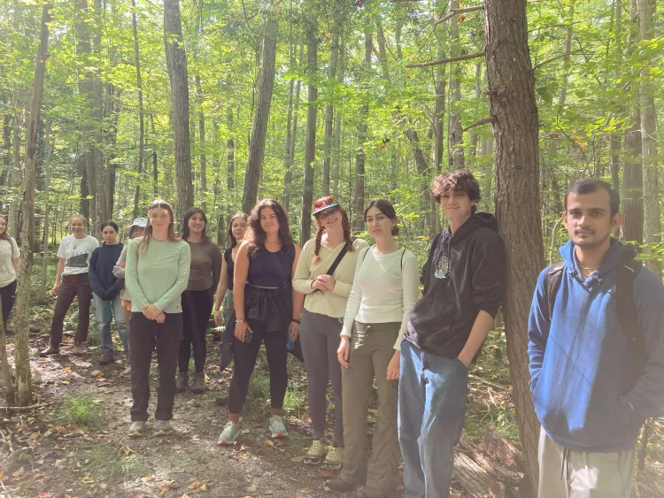 students standing in the woods.
