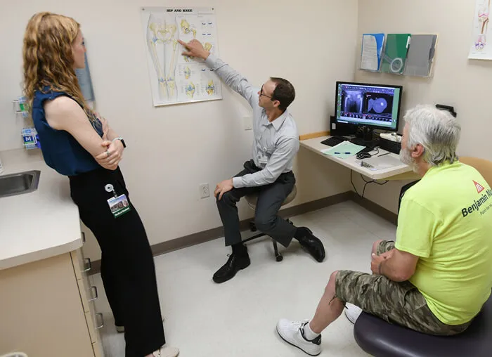 3 people in an exam room