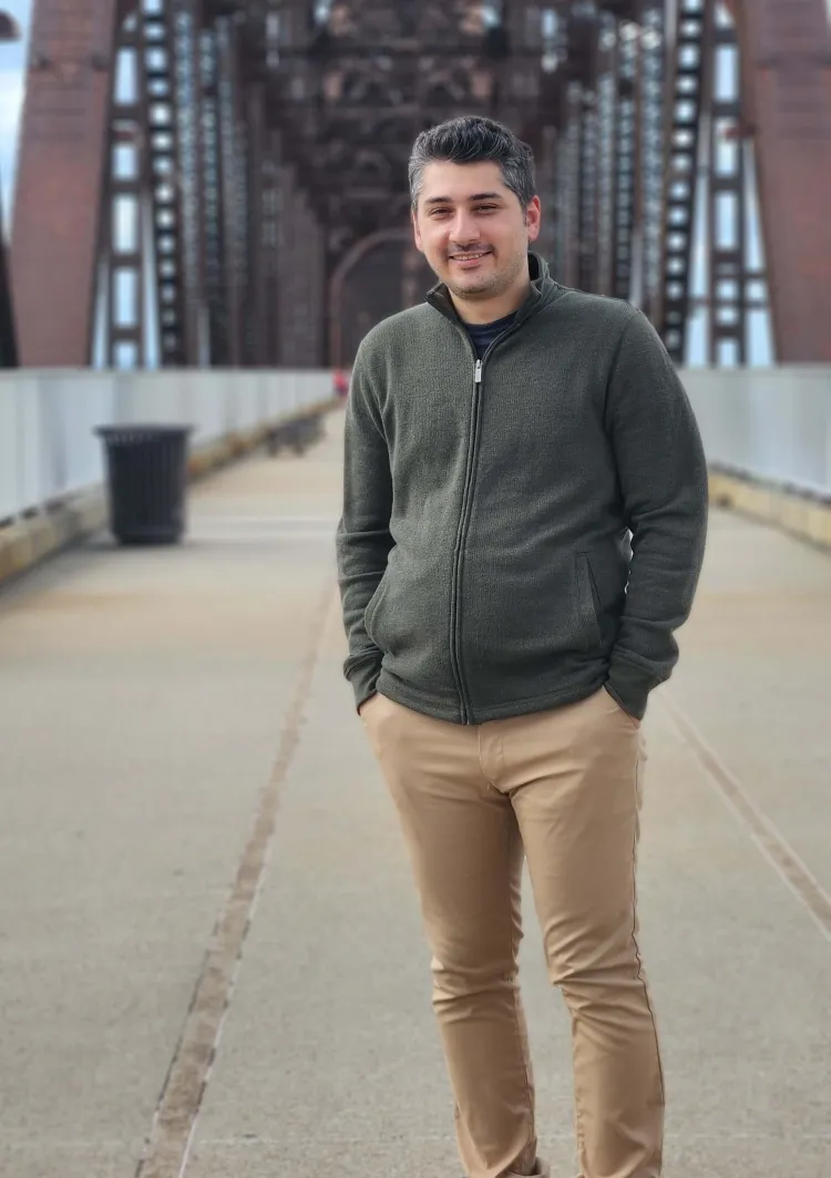 student standing near a bridge