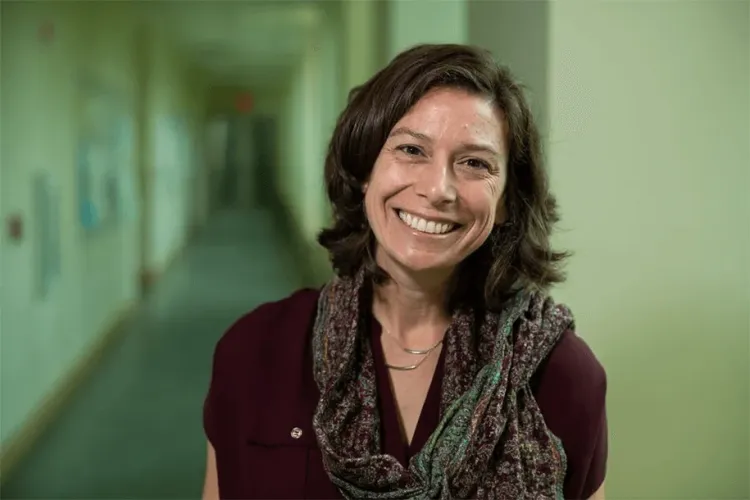 a person in a hallway smiling