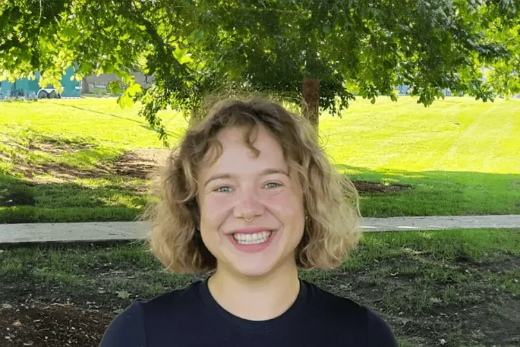 a person smiling outdoors