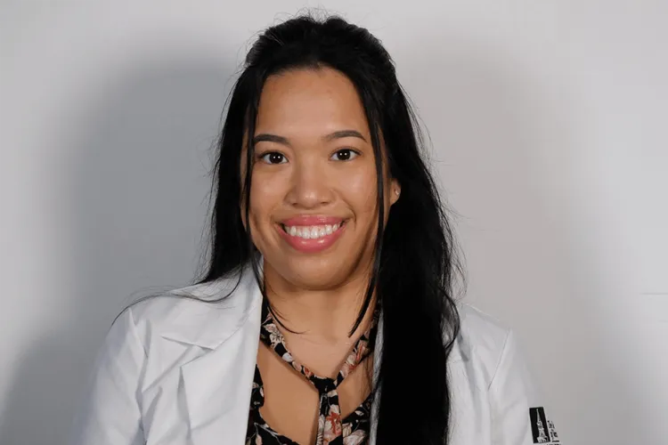 a person in a white coat smiling