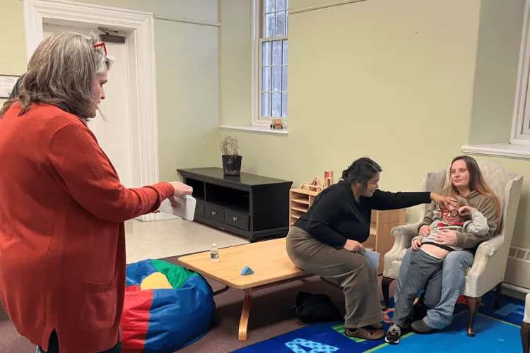 3 adults and a child in a room