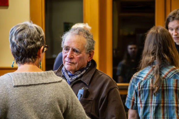 A man speaks to a woman