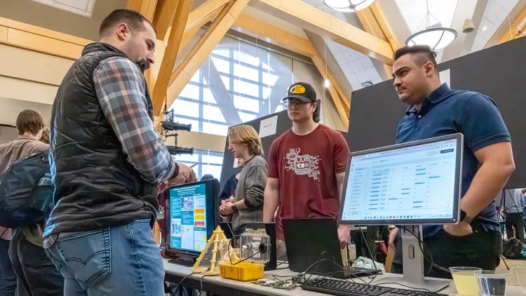 Student presenting their computer science fair project to a judge