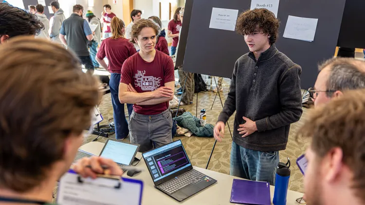 A student shares his fair project with judges