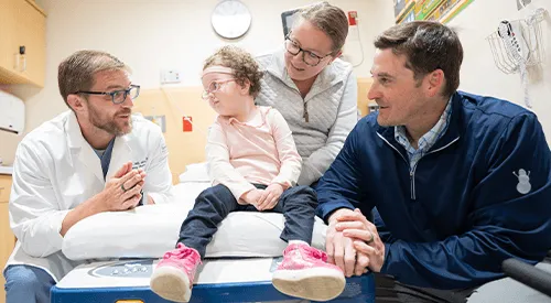 Christian Pulcini, M.D., M.P.H., M.Ed., with a child patient and family