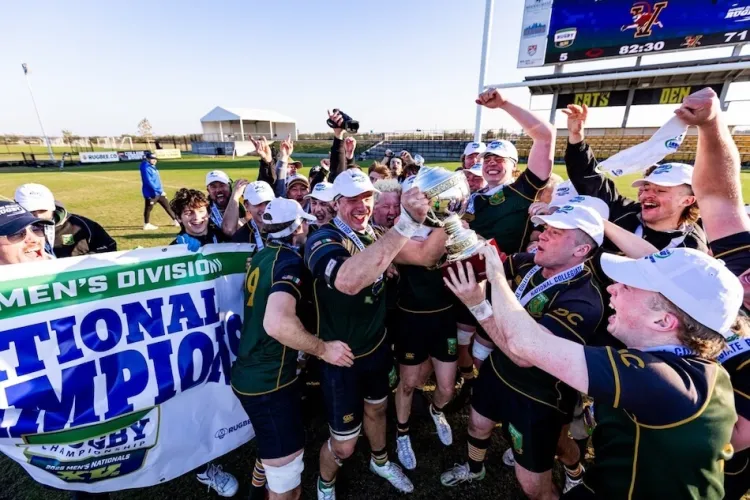 A group of rugby players celebrating with their trophy