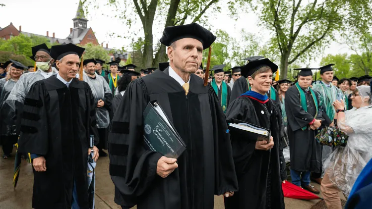 people in academic regalia at a commencement ceremony