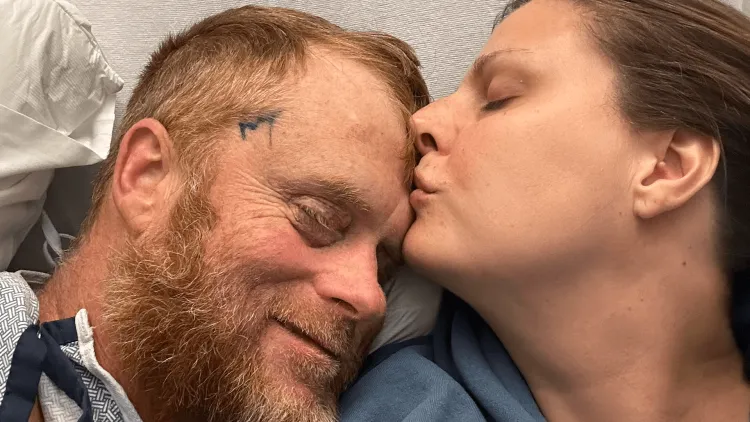a husband and wife in a hospital bed
