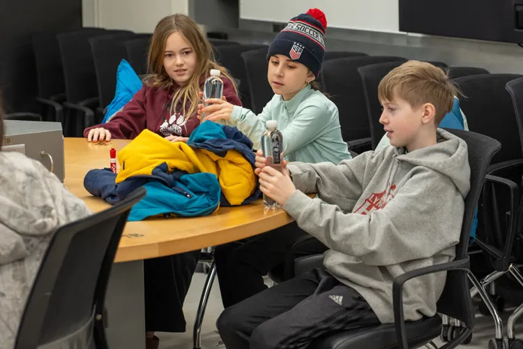 Middle school students participate in a physics demonstration