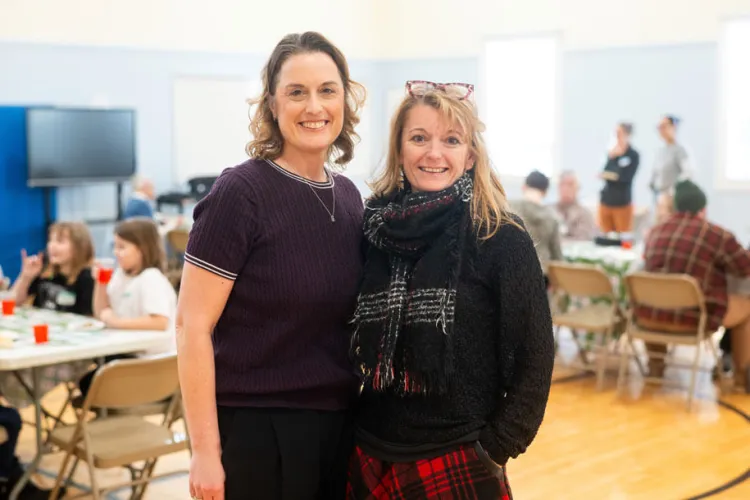 Cynthia Herbert and Shelly Lanou hug at the lunch
