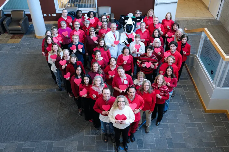 Larner community members pictured from above standing in a heart shape
