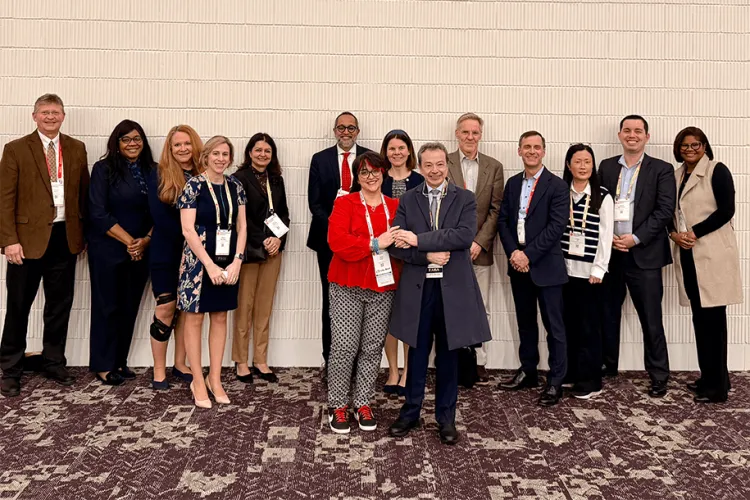 a group of people posing at an academic conference