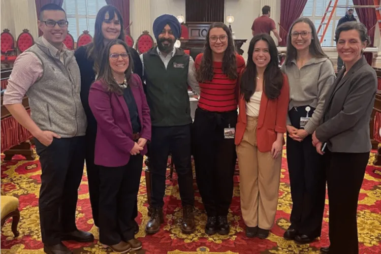 a group of people posing in the Vermont State House