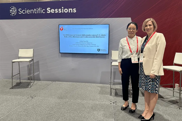  2 people standing on a stage at a conference