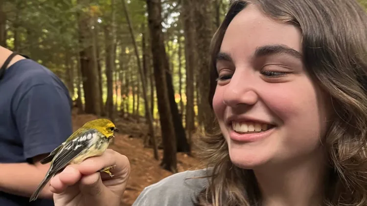 Hailey Backer holding a bird.
