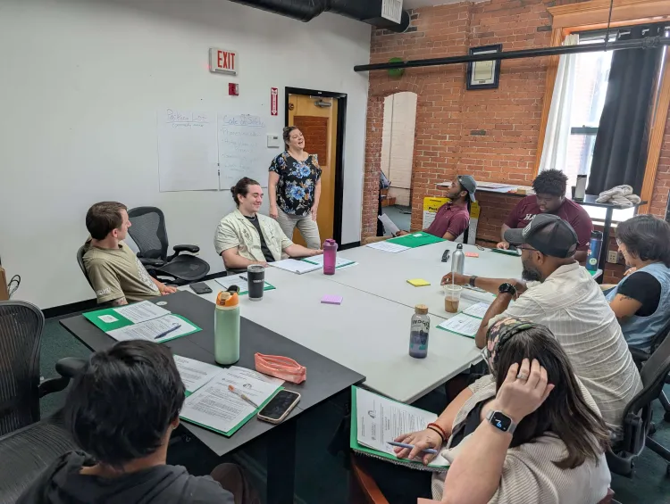 People sitting around a table in a conference room.