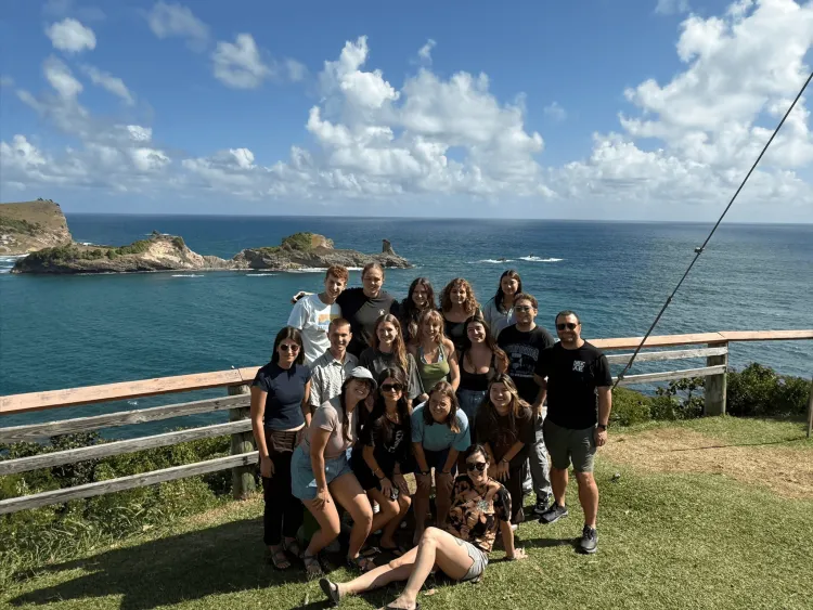Group of students in front of a Caribbean ocean beach
