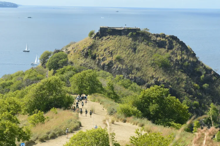 Beach mountain area with students walking down a path