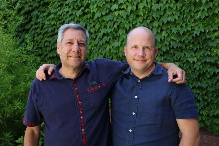Ernesto Mendez and Colin Anderson smiling