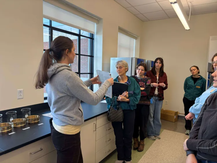 Lab manager demonstrating soil testing