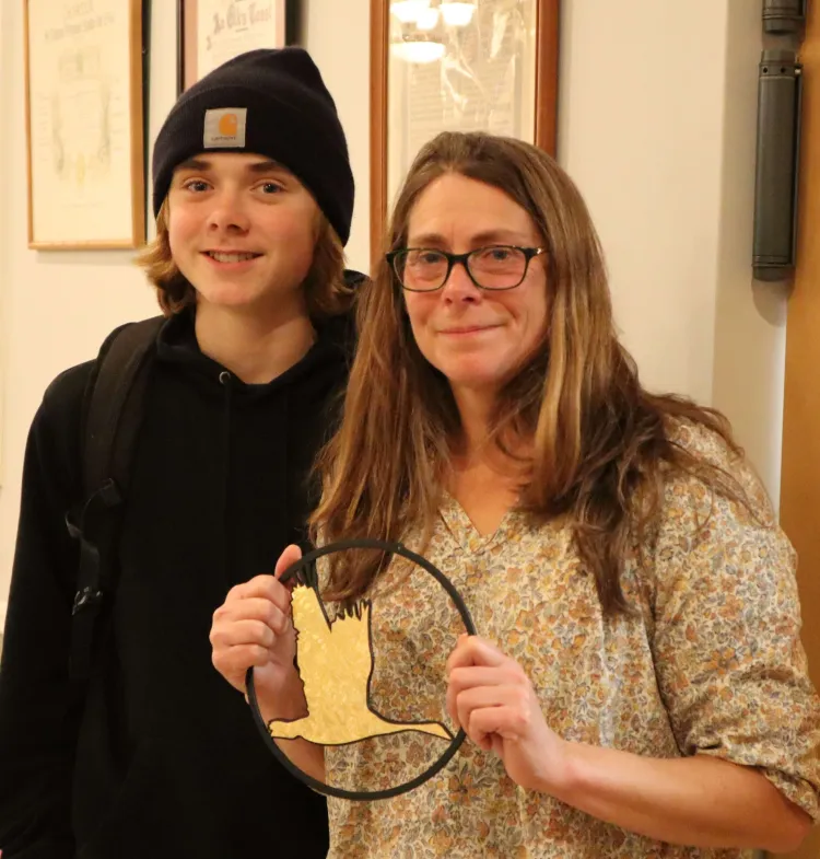 A woman and her son accept an award