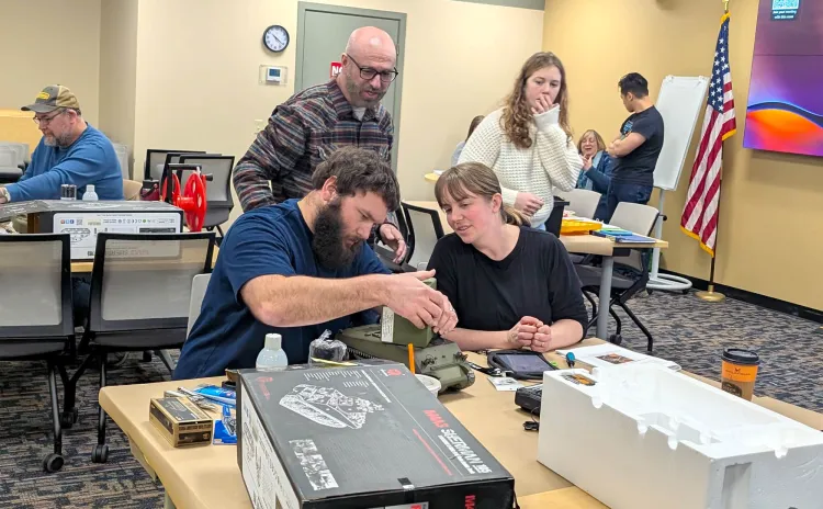 Under the watchful eyes of Mechanical Engineering Assistant Professor Dylan Burns and Workshop Coordinator Leah Dennis, VTrans employees assemble their DIY culvert inspection tank.