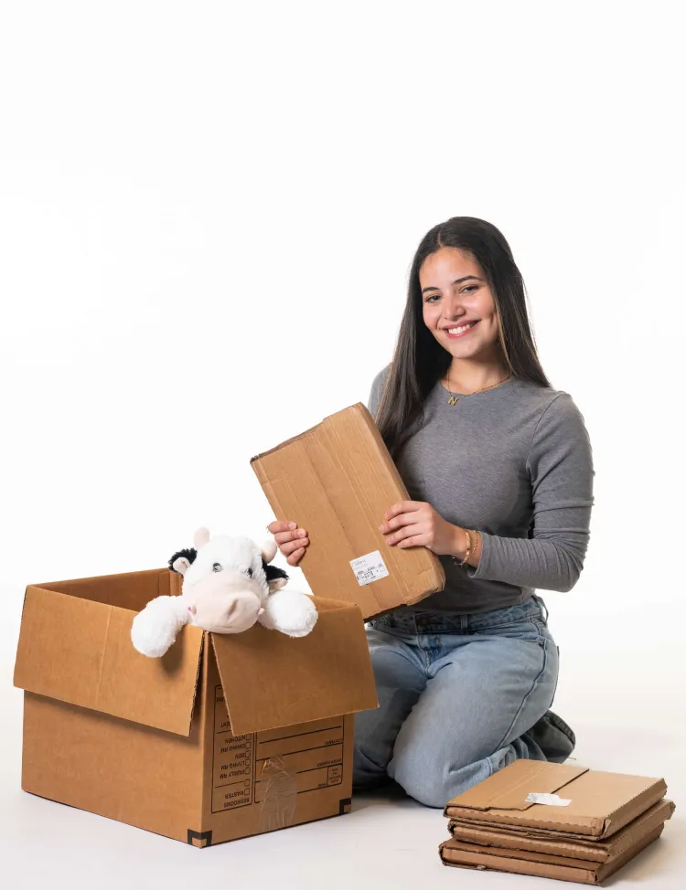 Woman packing books into a cardboard box