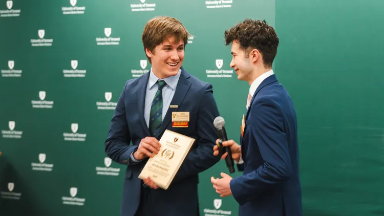 Otto Berckmueller receives the Student Leadership Award placard from Joe Anderson