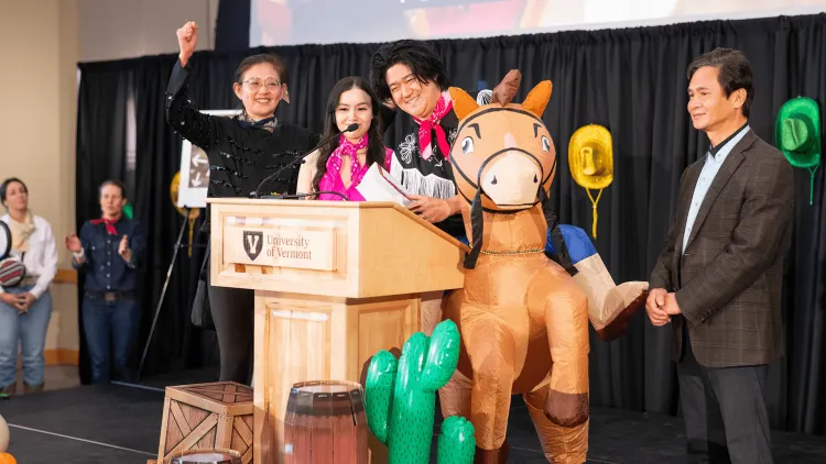 a group of people with an inflatable horse celebrating on a stage
