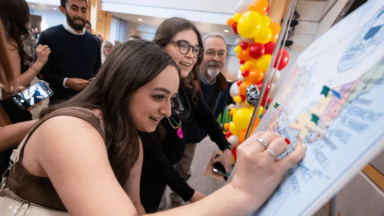 a person pushing a pin into a map board