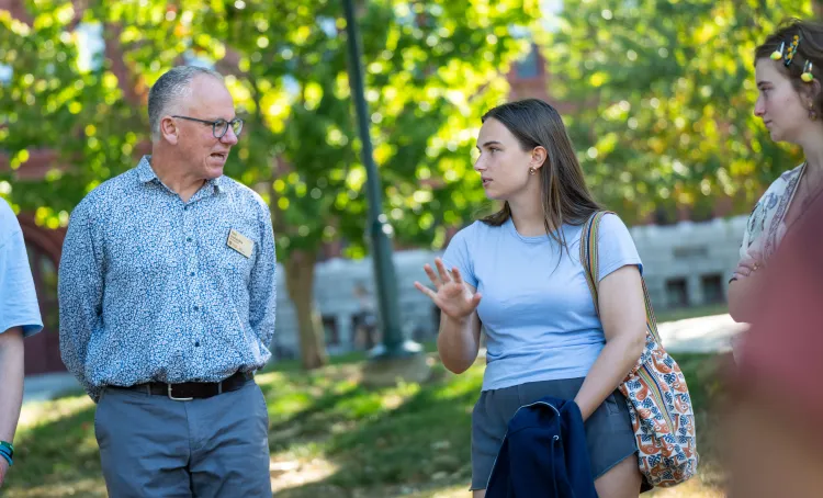 Two people talking outside in the sun