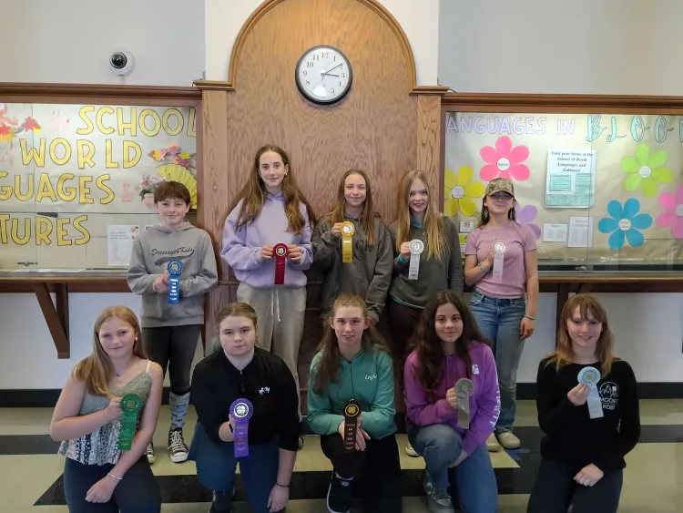 10 kids holding ribbons