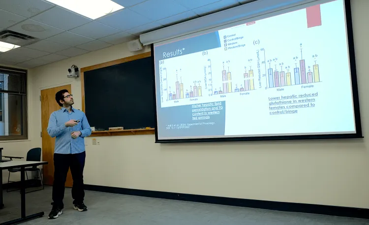 Man presenting research results in a classroom