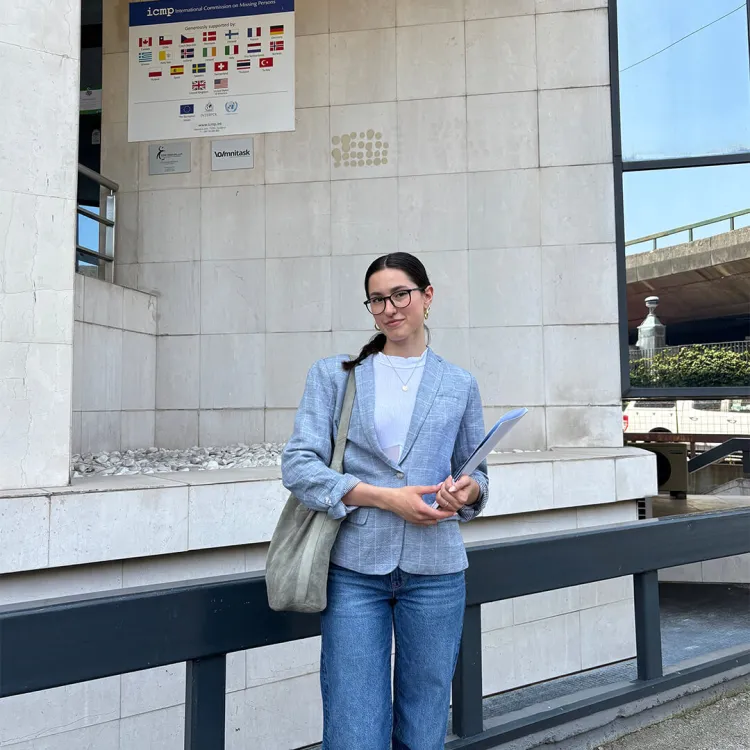 Asja Tuco stands outside a building