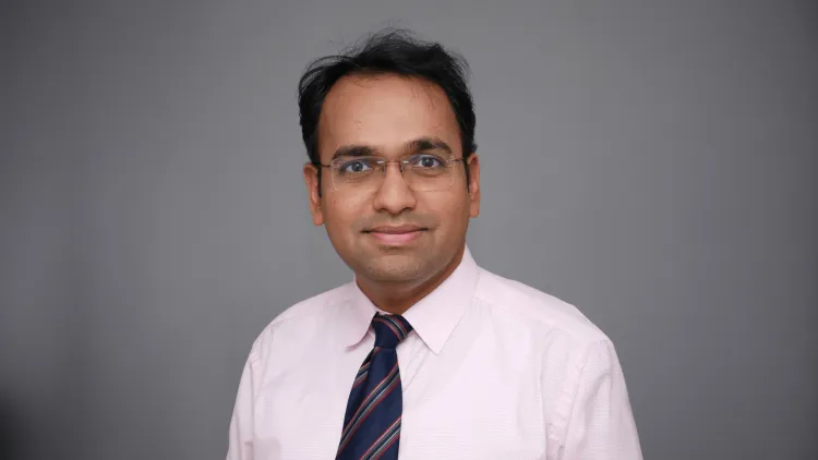 A person smiling at the camera. 