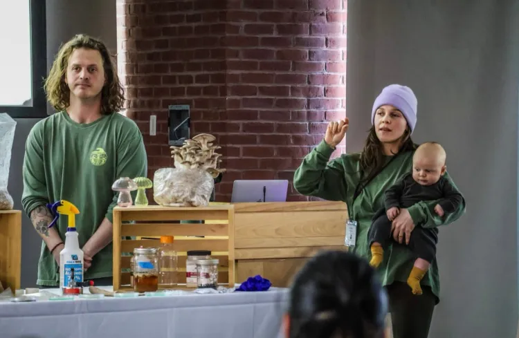 A couple with their baby selling mushrooms