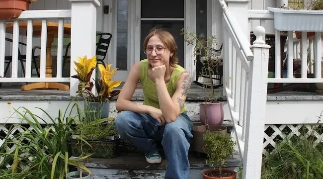 a person sitting on the front steps of a house