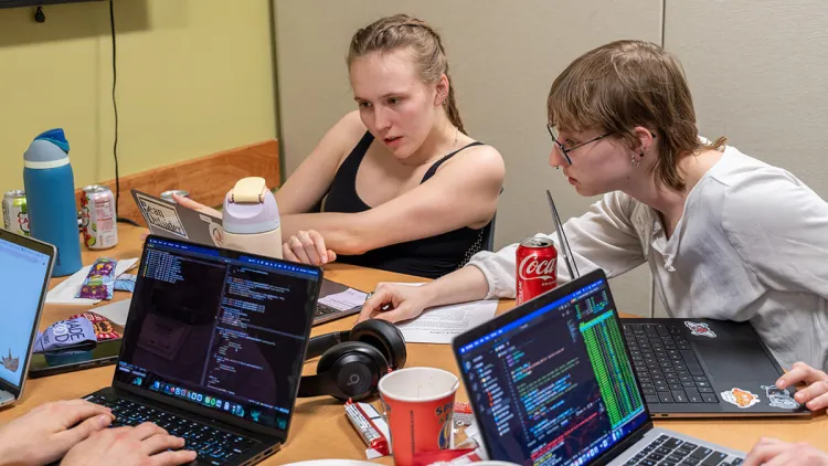 Two students collaborate during a computer science hackathon