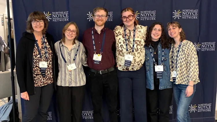 Six individuals pose in front of a banner for the Noyce Scholarship Program