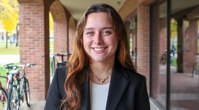 portrait of a woman standing in front of a brick building