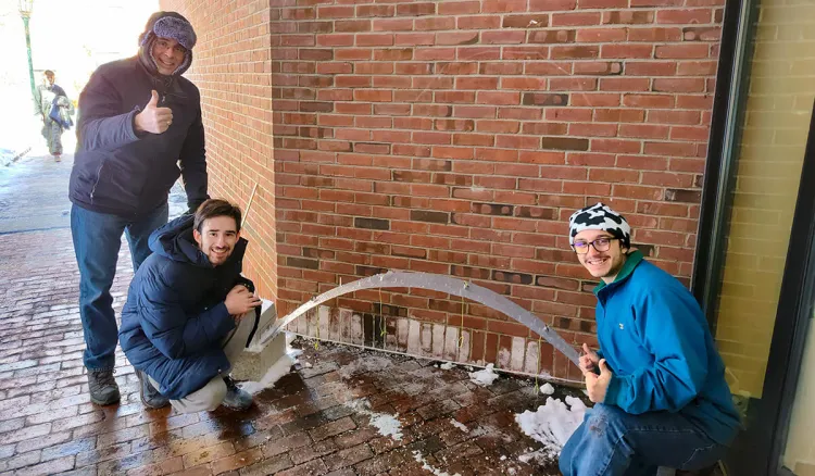 Professor Eric Hernandez and students working on a project outside
