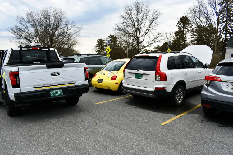 Parking Enforcement vehicle assisting a student on campus with a jumpstart