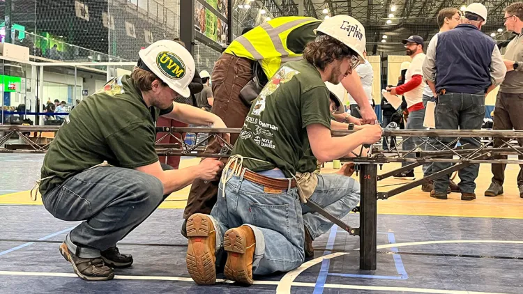 UVM's ASCE Steel Bridge team erects their bridge during a competition
