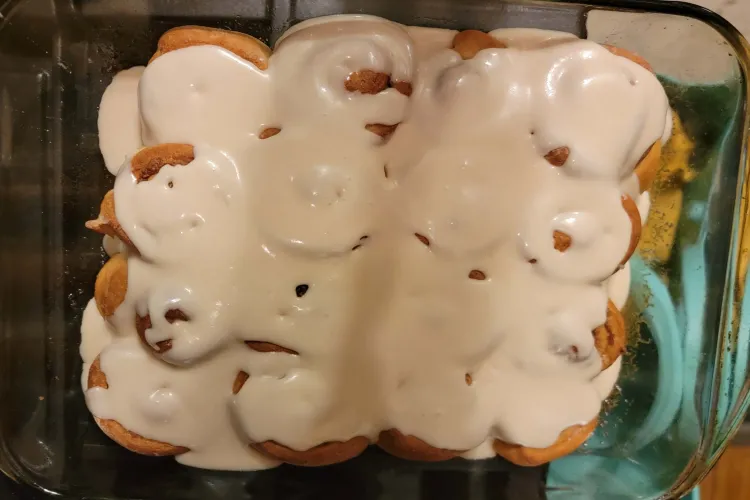 A top-down view of frosted cinnamon rolls.