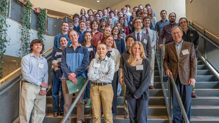 Student and faculty gathered on stairs for a group photo