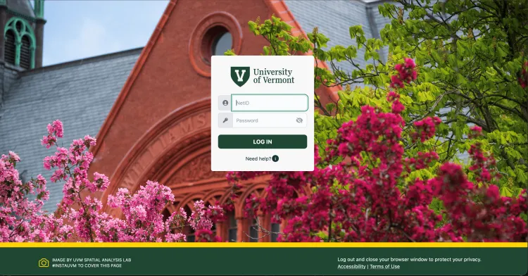 current sso login page with pink and red flowers on the lower half of the screen, a brick gable of a building in the upper half, and a login form with the University of Vermont V logo at center